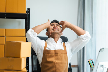 Startup SME small business entrepreneur of freelance Asian Indian man wearing apron prepare parcel...
