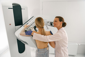 Female radiologist doing mammogram x ray for woman to check for breast cancer. High quality photo