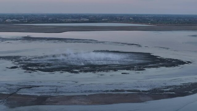 Lapindo volcanic mudflow in Porong, Surabaya, Indonesia. View of hot mud gushing out of a gas and oil mine in Indonesia