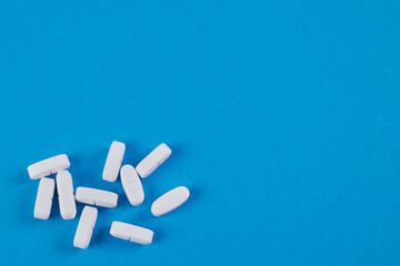 blue background with white pills in below left corner, space for text