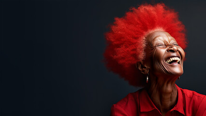 Happy, laughing, lovely old woman, with red afro hair, on solid colour background, with room for text.