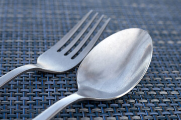 Spoon and fork on place mat