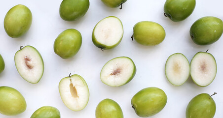 Green jujube fruits on white background.