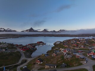 aerial view of foggy sky sunset in Tasiilaq fjord in Greenland