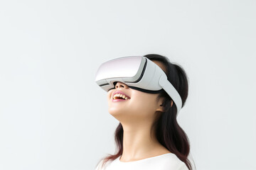 Fototapeta premium Young woman wearing virtual reality VR glasses, VR headset and trying to touch something with her hand while standing on white background.