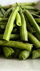 Macro shot closeup of  fresh green beans out of the garden and stacked in a pile and cut into pieces