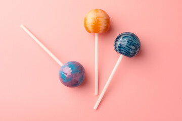 Tasty lollipops on pink background, flat lay