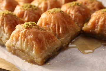 Delicious sweet baklava with pistachios on table, closeup
