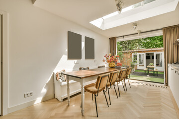 a dining room with wood flooring and skylights on the ceiling, as well as it is in this house