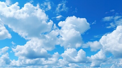 Naklejka na ściany i meble Blue sky background with white clouds. Cumulus white clouds in the blue sky