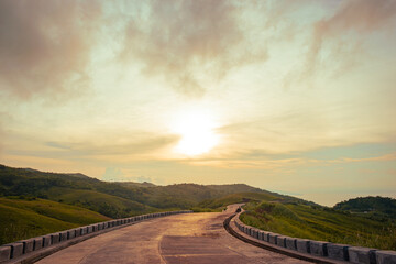 Along the long road in the mountains at sunrise. Cabaliwan Peak, Romblon, Philippines.