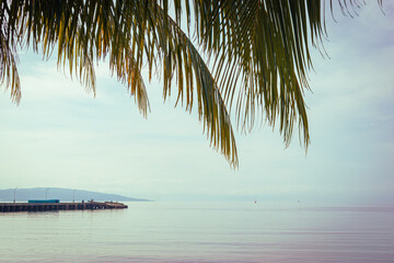 Tropical island over the calm sea. San Agustin, Romblon, Philippines.