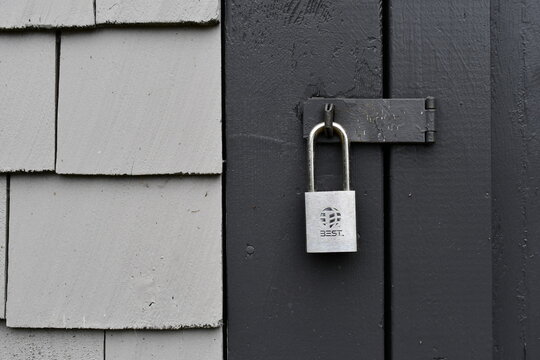 BEST brand padlock on wooden door.
