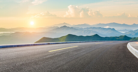 Asphalt highway road and mountain natural scenery at sunrise. panoramic view.