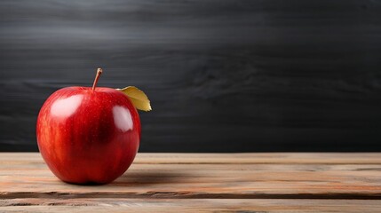 Vibrant red apple on wooden table
