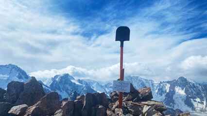 View of the top of Uchitel Peak in the mountains of Kyrgyzstan. A shovel in the rocks. Ala Archa...