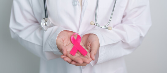 Pink October Breast Cancer Awareness month, doctor with pink Ribbon in hospital for support people life and illness. National cancer survivors month, Mother and World cancer day concept