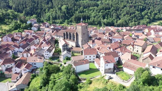 Dense urban development of medieval Spanish town of Isaba, view from above. Wide view of settlement and adjacent forests and mountains, view from observation deck, from quadrocopter drone
