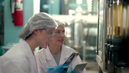 scientist woman worker checking and monitoring the control panel on machine system at the industrial factory. Female worker recording data at the control panel with measure pressure of water level. - Powered by Adobe