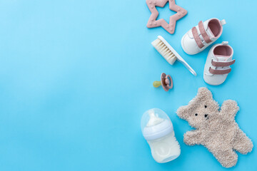 Baby's first accessories beautifully presented on blue surface
