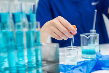 laboratory glassware equipment for medicals science chemistry research, blue liquid in scientific glasses flask, test tube, and beaker for chemical medicine experiment or biology technology analysis