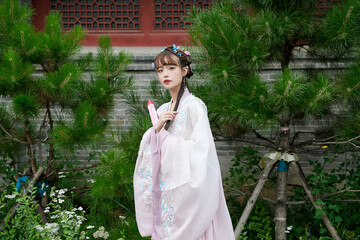 An Oriental beauty in ancient attire holding an umbrella