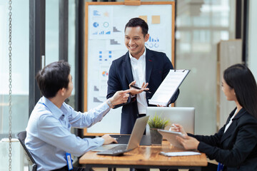 Business man present strategy plan on tablet to corporate colleagues in the office
