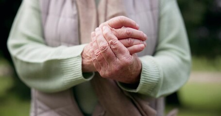 Hands, pain and a senior person with arthritis outdoor at a park in summer closeup during retirement. Anatomy, osteoporosis or joint massage with an elderly adult in a garden for a medical issue