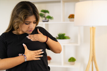 Woman examining her breast to check for breast cancer