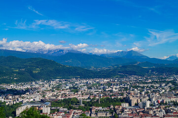 Fototapeta na wymiar Aerial view of Grenoble old town seen from Bastille Fort, Auvergne-Rhone-Alpes region, France, Europe. View from above on the Isere Valley in the French Pre-Alps. Chartreuse Belledonne mountain range