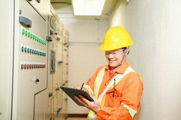 Smart Female Maintenance Engineer using digital tablet and standing in front of control room,Close up hand of engineer or electrician man working check the electrical system with tablet