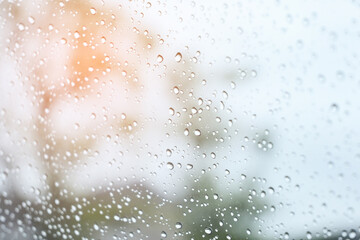 blur background with sunlight on rainy day, water droplet on mirror