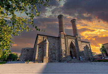 Naklejka premium Erzurum Double Minaret Madrasa, one of the Turkish historical buildings. Erzurum Double Minaret Madrasa at sunrise in summer. It is one of the most famous travel routes in Turkey. Erzurum, Turkey