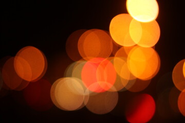 A black background with a golden light bokeh effect. 