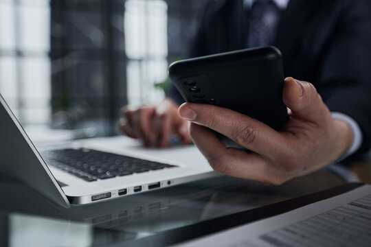 Business Man Hands Busy Using Cell Phone At Office Desk