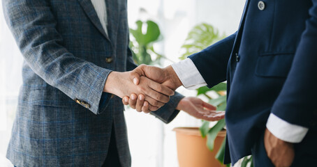 Business partnership handshake concept.Photo two coworkers handshaking process.Successful deal after great meeting. in office..