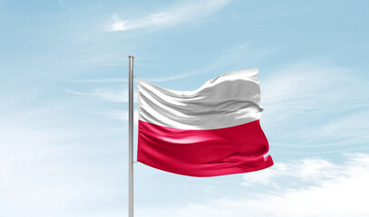 Naklejka na ściany i meble Poland national flag waving in beautiful sky. The symbol of the state on wavy silk fabric.