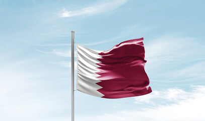 Qatar national flag waving in beautiful sky. The symbol of the state on wavy silk fabric.