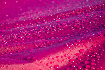 Close up water drop on the pink fabric. Abstract water drop on pink fabric background.