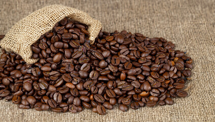 Coffee beans on gunny sack background