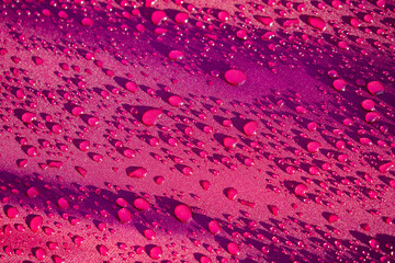 Close up water drop on the pink fabric. Abstract water drop on pink fabric background.
