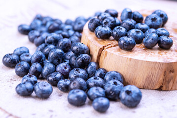 Freshly picked organic blueberries with water drops on a wooden stand