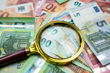  magnifying glass above euro banknote as finance background