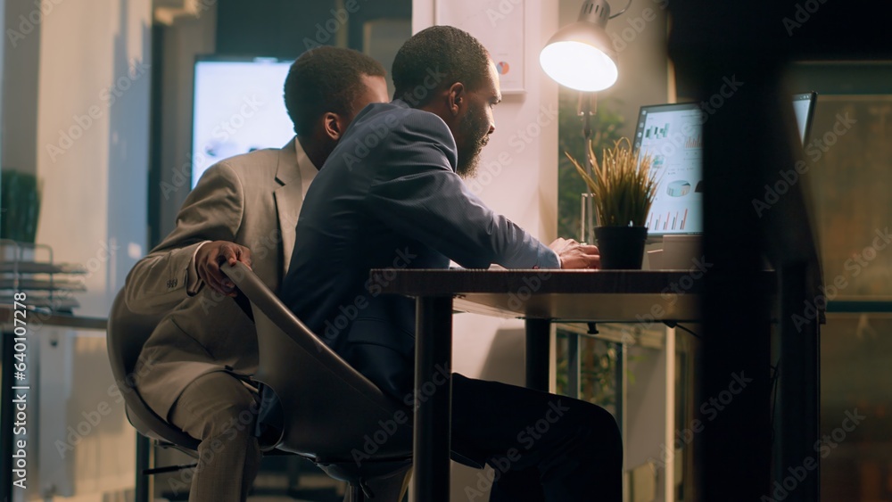 Poster manager in office crosschecking financial figures on every employee computer, making sure they are c