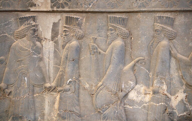 Ancient wall with bas-relief with assyrian foreign ambassadors with gifts and donations,...