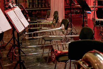 three trombones of a symphony orchestra during intermission lies on the stage