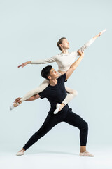 Ballet Concepts. Young Man and Caucasian Woman Performing As Ballet Dancers Over Grey in Studio During Suppots As Classical Dance Aesthetics With Choreography Art © danmorgan12