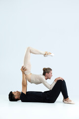 Asian Young Man and Caucasian Woman Performing As Ballet Dancers Over Grey in Studio During Suppots As Classical Dance With Choreography Aesthetics Art
