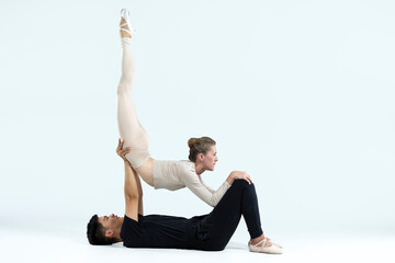 Asian Young Man and Caucasian Woman Performing As Ballet Dancers Over Grey in Studio During Suppots As Classical Dance Aesthetics With Choreography Art © danmorgan12