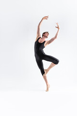 Ballet Dancer Young Man in Black Dance Suit Posing in Ballanced Dance Pose Studio On White.